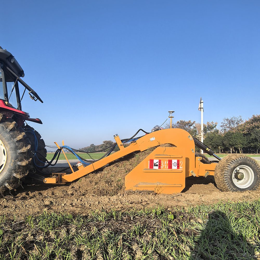 Land leveler working under clear sky