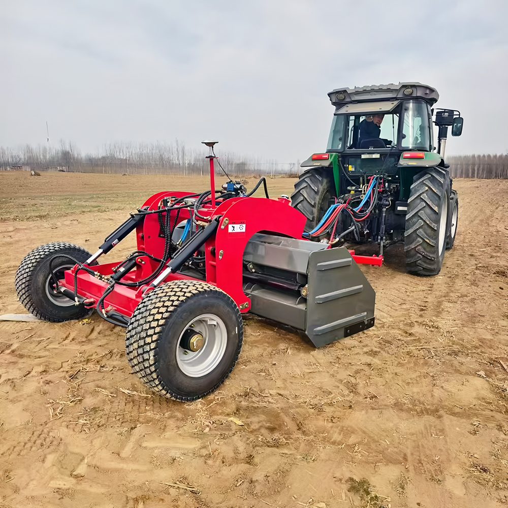Land leveler towed by tractor in the field